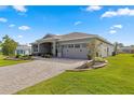Two-story home with landscaping, paver driveway, and two car garage at 9617 Sw 102Nd Ter, Ocala, FL 34481