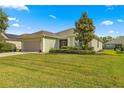 House exterior showcasing a green facade and lush landscaping at 6651 Sw 93Rd Ct, Ocala, FL 34481