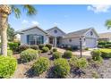 One-story home with teal accents and lush landscaping at 8325 Sw 82Nd Cir, Ocala, FL 34481