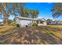 Side view of the house, highlighting the yard and landscaping at 11205 Sw 63Rd Terrace Rd, Ocala, FL 34476