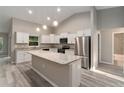 Modern kitchen with white cabinets, granite countertops, and an island at 8285 Sw 129Th Terrace Rd, Dunnellon, FL 34432