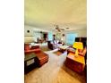 Living room with leather sofas and a view to the dining area at 24910 Ne 132Nd Pl, Salt Springs, FL 32134