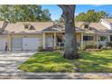 House front showcasing a covered porch and landscaping at 9256 Sw 82Nd Ter # E, Ocala, FL 34481