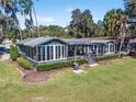 Lakefront home with a deck, landscaping, and beautiful lake view at 10410 Se 138Th Place Rd, Summerfield, FL 34491