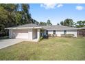 Ranch-style home with attached garage and yard at 14185 Sw 30Th Pl, Ocala, FL 34481