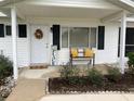 Inviting front porch with decorative wreath and seating at 11217 Sw 76Th Ter, Ocala, FL 34476