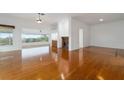 Spacious living room featuring hardwood floors and large windows at 6042 Topsail Rd, Lady Lake, FL 32159