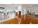 Bright living room with hardwood floors, fireplace, and view at 6042 Topsail Rd, Lady Lake, FL 32159