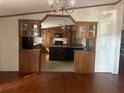 View of kitchen with an island and dark wood cabinets at 8685 Sw 67 Ct, Ocala, FL 34476
