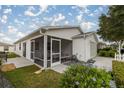 House exterior with screened porch and landscaping at 2610 Hialeah Ave, The Villages, FL 32162