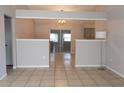 Dining room with tile floors and a view into the kitchen at 21 Pecan Course Cir, Ocala, FL 34472