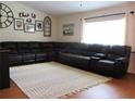 Relaxing living room with a large sectional sofa and decorative rug at 14861 Sw 112Th Cir, Dunnellon, FL 34432