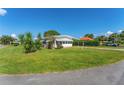 Mobile home with carport and a well-kept lawn at 903 Aloha Way, Lady Lake, FL 32159