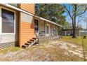 House exterior showcasing side porch and detached shed at 10135 Se 108Th Terrace Rd, Ocala, FL 34472