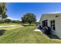 Home's backyard features a screened patio, grill, and golf course view at 15590 Sw 11Th Terrace Rd, Ocala, FL 34473