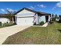 House exterior with two-car garage and landscaping at 9407 Sw 53Rd Pl, Ocala, FL 34481