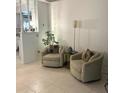 Living room with two armchairs and a floor lamp at 170 Gary Ave, Oak Hill, FL 32759