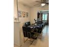 Dining room with a black marble table and gold chairs at 170 Gary Ave, Oak Hill, FL 32759