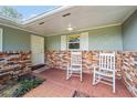 Brick front porch with two rocking chairs at 4812 Ne 12Th St, Ocala, FL 34470