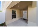 Covered entryway with a window and exterior door at 1204 Flamingo Pl, The Villages, FL 32162