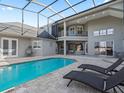 Relaxing pool and patio with covered lanai and lounge chairs at 6892 Nw 54Th Loop, Ocala, FL 34482