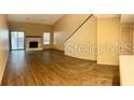 Living room with fireplace and laminate flooring at 3824 Ne 17Th Street Cir, Ocala, FL 34470