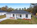 Newly built home with gray roof and landscaping at 13237 Sw 114 Pl, Dunnellon, FL 34432