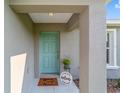 Inviting front door entrance with a welcome mat and potted plant at 16356 Sw 27Th Cir, Ocala, FL 34473