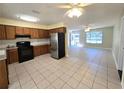 Kitchen with wood cabinets, stainless steel appliances, and tile floor at 6361 Nw 57Th Ave, Ocala, FL 34482