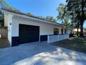 White house with black garage door and stone accents at 3425 Ne 33Rd Ave, Ocala, FL 34479