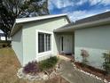 Light green house with white door and landscaping at 5199 Nw 18Th St, Ocala, FL 34482