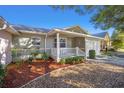 Single-story house with white porch and well-kept landscaping at 9393 Sw 97Th Pl # C, Ocala, FL 34481