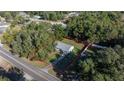 Single-story house on a lot with trees and a road nearby at 9554 Bahia Rd, Ocala, FL 34472