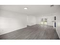 Spacious living area with gray flooring and access to backyard at 9554 Bahia Rd, Ocala, FL 34472