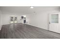 Bright living room with gray vinyl flooring and French doors at 9554 Bahia Rd, Ocala, FL 34472