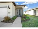 Front door entry with a screened porch and nicely landscaped walkway at 6119 Sw 93Rd Cir, Ocala, FL 34481