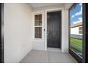 Small screened porch with a black front door and a window at 6119 Sw 93Rd Cir, Ocala, FL 34481