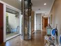 Elegant entry with glass elevator and polished concrete floors at 12757 Se 143Rd Ave, Ocklawaha, FL 32179