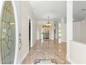 Elegant entryway with a glass-paneled door and marble flooring at 2350 Nw 59Th Ave, Ocala, FL 34482