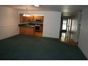 Spacious living room with carpeting, a view of the kitchen, and wood flooring at 3706 Ne 16Th Pl, Ocala, FL 34470