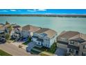 Two-story light blue house with lake view and street parking at 455 Blue Cypress Dr, Groveland, FL 34736