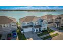 Two-story light blue house with lake view and boat dock at 455 Blue Cypress Dr, Groveland, FL 34736