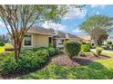 Single-story home with manicured landscaping and a two-car garage at 8470 Sw 82Nd Cir, Ocala, FL 34481