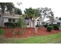 Single story house with red mulch beds and lush landscaping at 8473 Sw 108Th Place Rd, Ocala, FL 34481