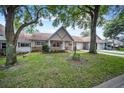 House exterior with lush lawn and mature trees at 8814 Sw 93Rd Ln # C, Ocala, FL 34481