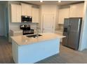 Modern kitchen featuring white cabinets, stainless steel appliances, and a large island at 9013 Sw 67Th Ave, Ocala, FL 34476