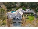 Aerial view of home showcasing pool, landscaping, and multiple buildings at 1150 Sw 43Rd Pl, Ocala, FL 34471