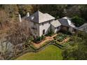 Aerial view showcasing home's design, gardens, and wooded surroundings at 1150 Sw 43Rd Pl, Ocala, FL 34471