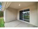 Covered patio with sliding glass doors leading to the backyard at 2647 Sw 154Th Ln, Ocala, FL 34473