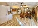 Open concept kitchen features white cabinets and granite countertops at 45202 Nfs Rd 572-B, Altoona, FL 32702